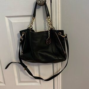 Black Micheal Kors with zipper side details, shoulder bag